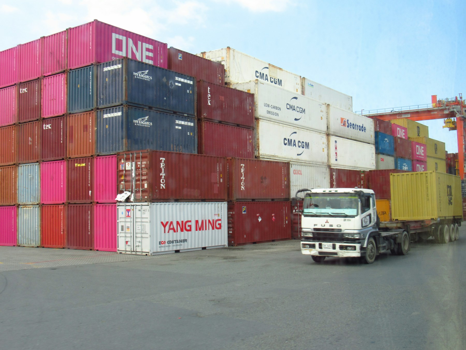 Truck moving through a busy container yard